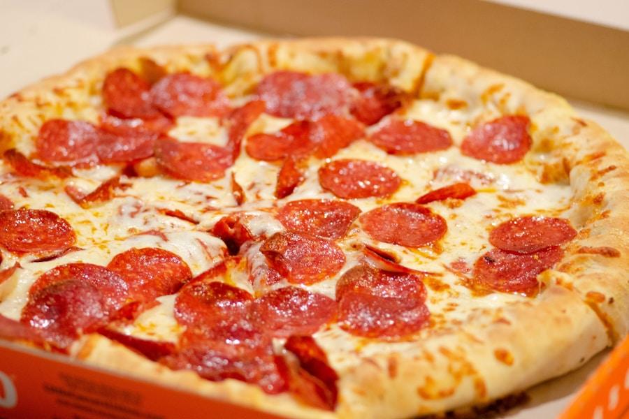 Multiple pizzas ready for a large group order, sliced and arranged for easy serving